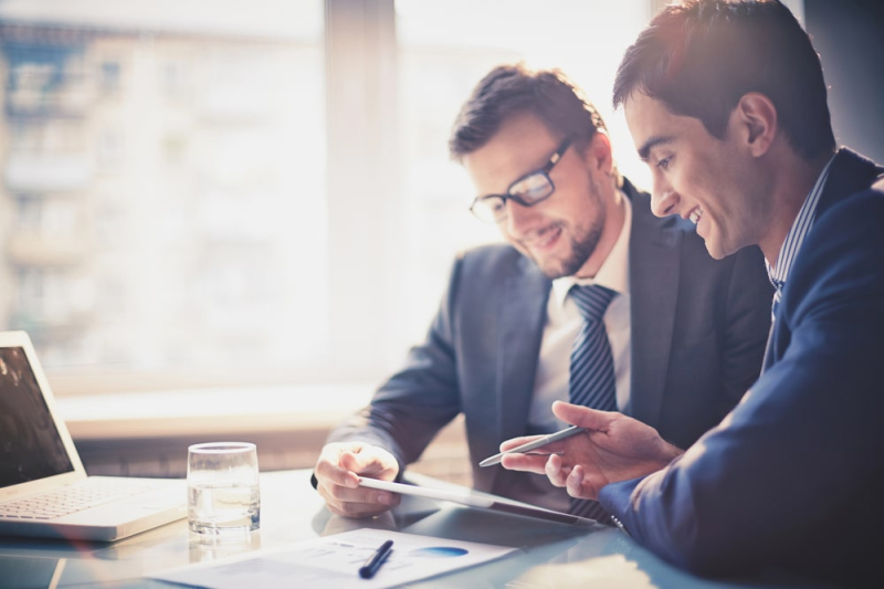 2 men at a desk discussing business line of credit loans in Australia