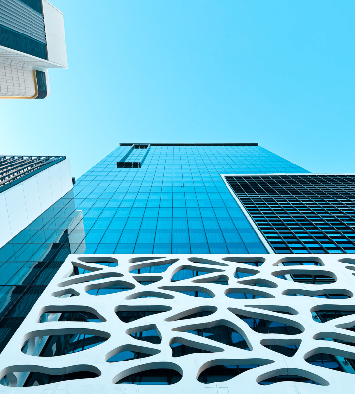 Outside of a high-rise business finance building from the bottom looking up.
