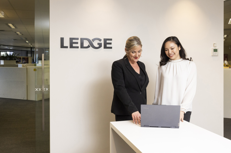 Elaine & Jenny standing at front desk.