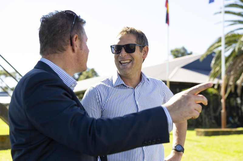 Isaac Hough standing with a Ledge client and talking.
