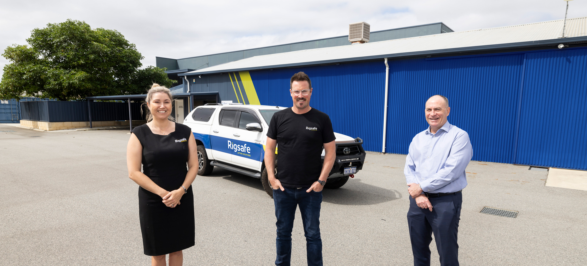 2 founders of Rigsafe, Tanya and Kevin, and Brad from Ledge Finance standing in front of a vehicle and Rigsafe's new warehouse