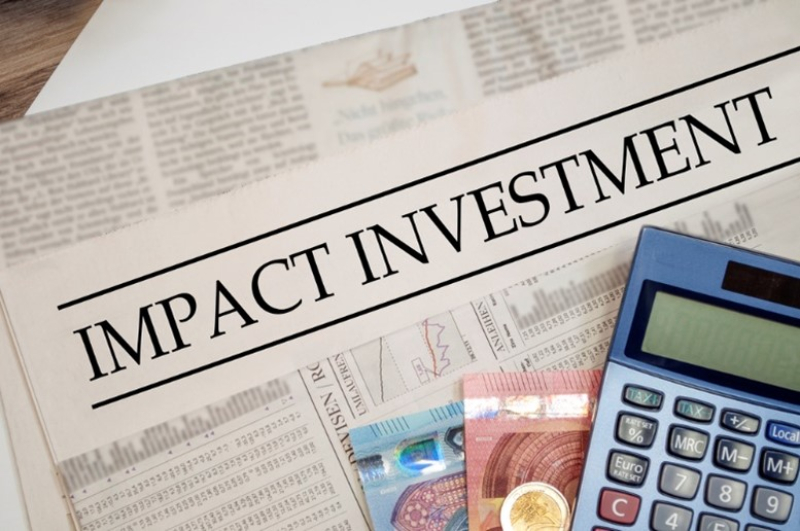 social impact investing newspaper article with calculator and money