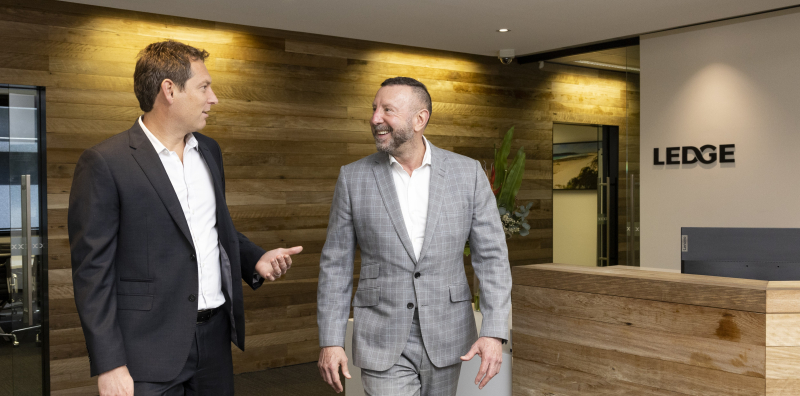 Business finance brokers Tony and Isaac from Ledge walking through the office foyer.