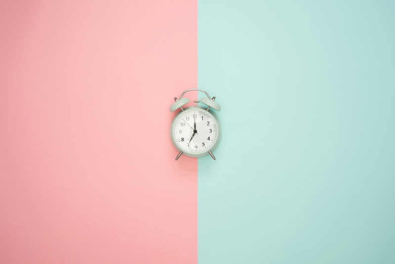 blue clock on pastel background