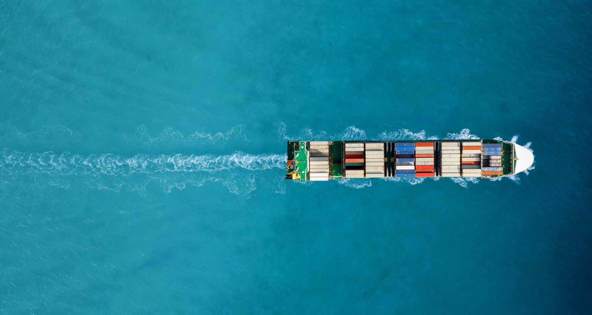 Aerial shot of a cargo ship transporting goods.
