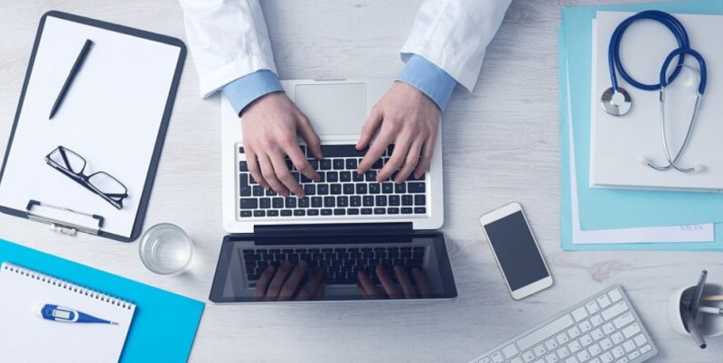 Birds eye view of health professional on laptop.