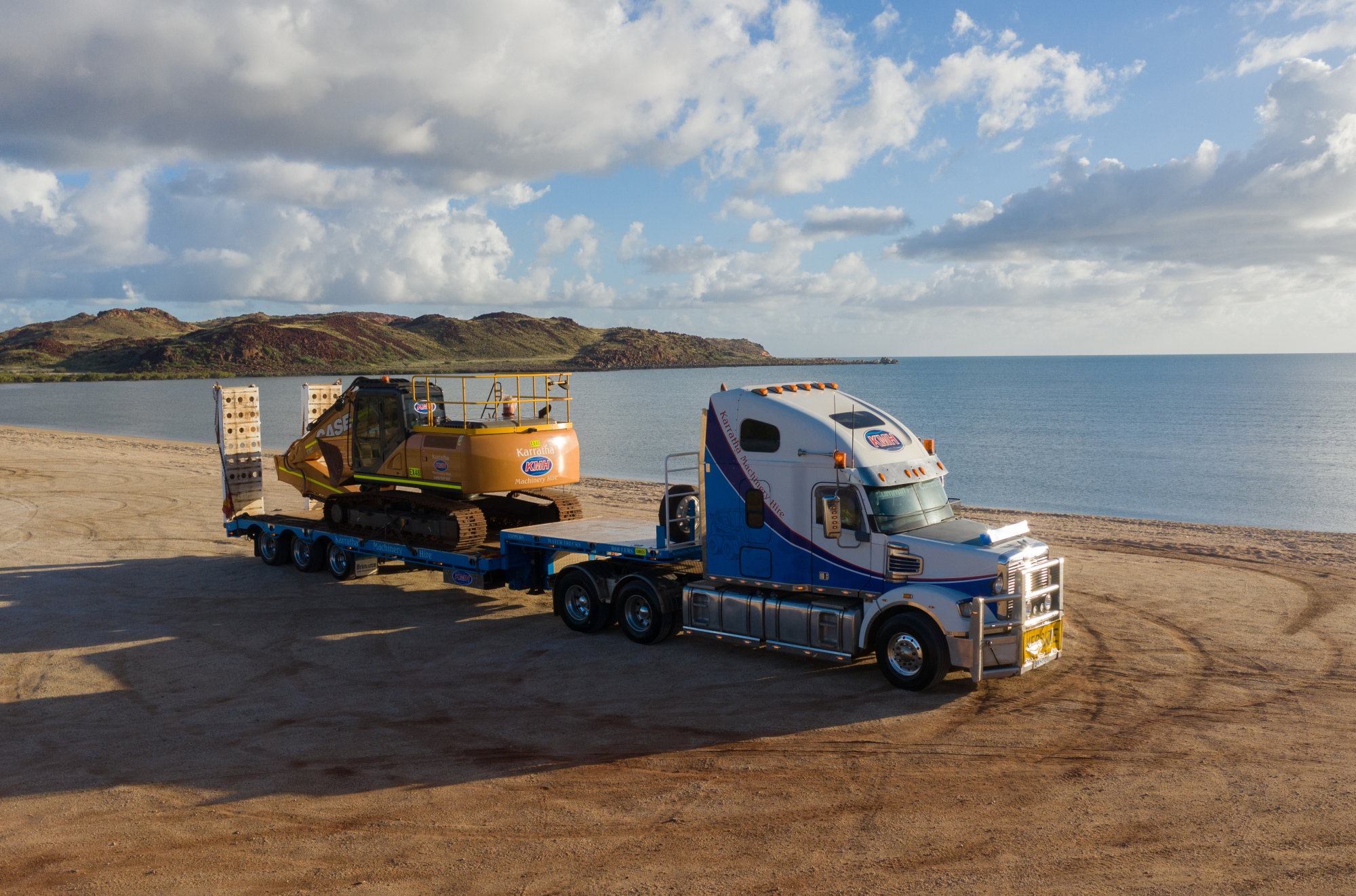 Truck towing a piece of machinery.