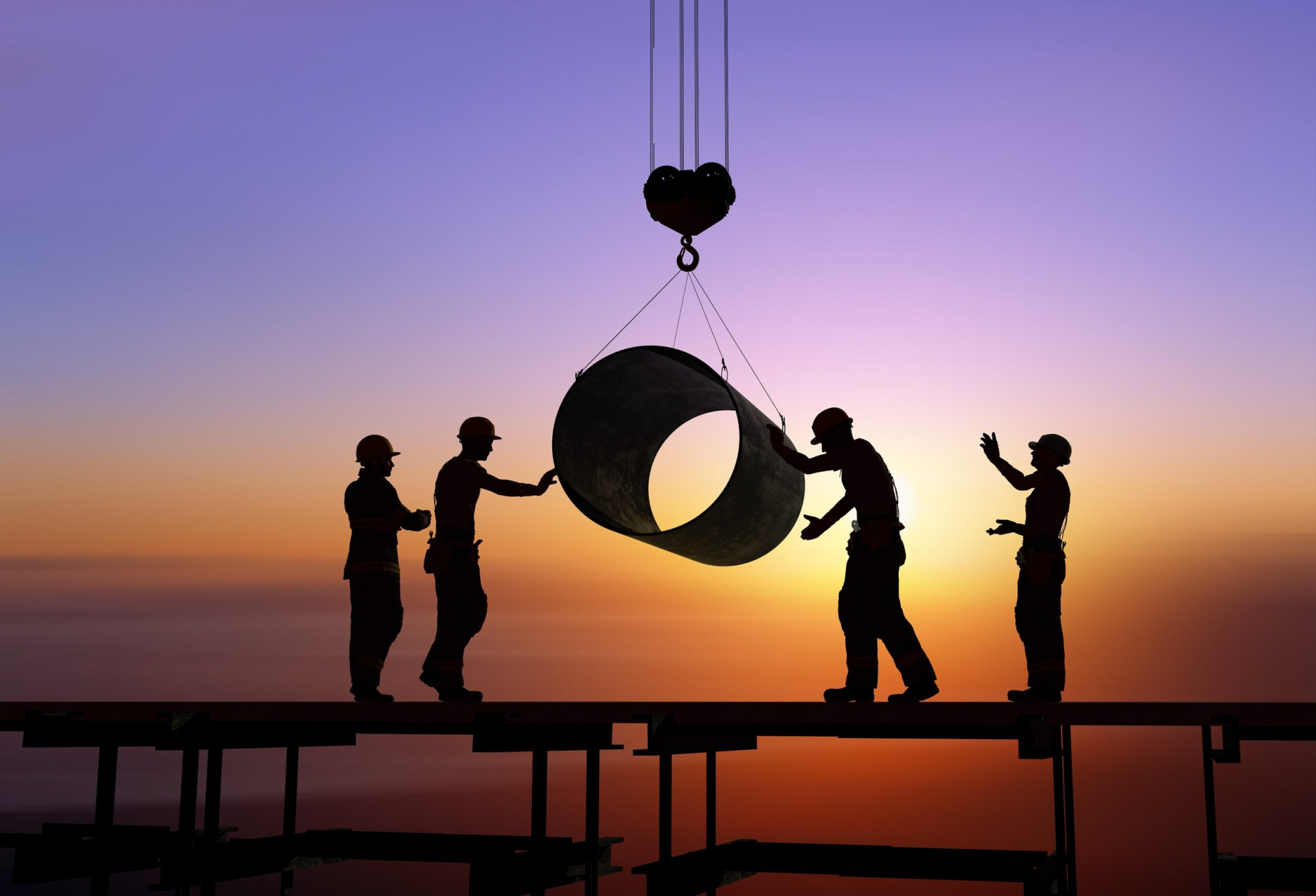 Outline of workers on a construction site with the sun setting in the background.