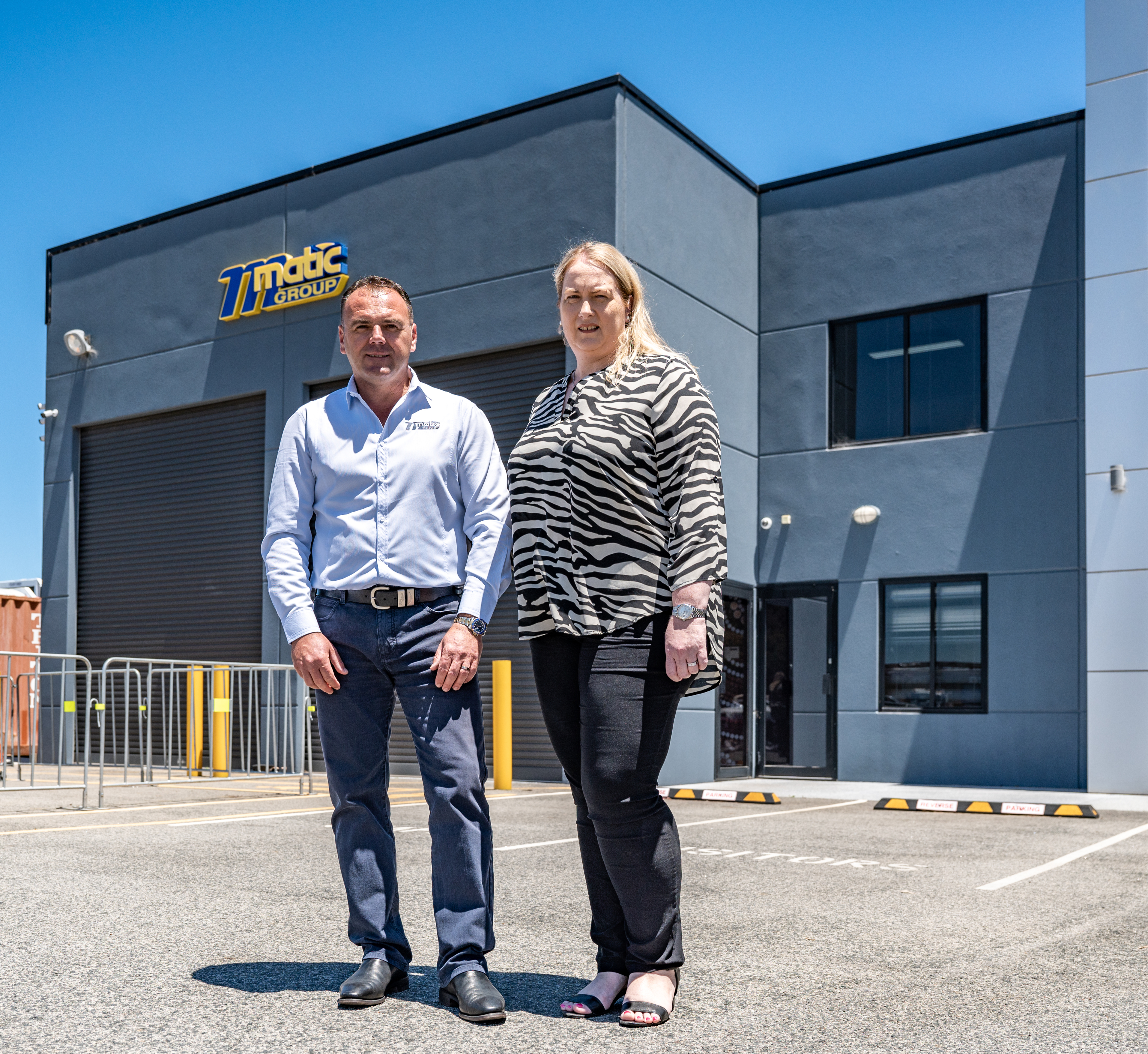 Katia and Danny Matic standing in front of Matic Group building
