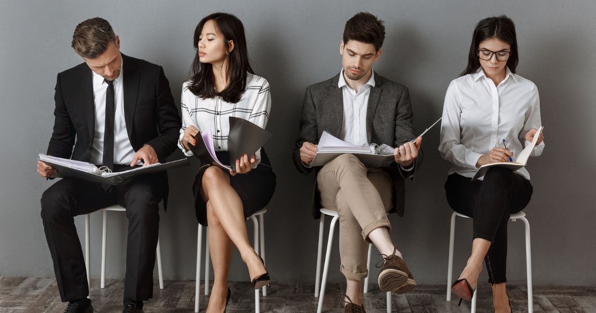 four people waiting to have a job interview
